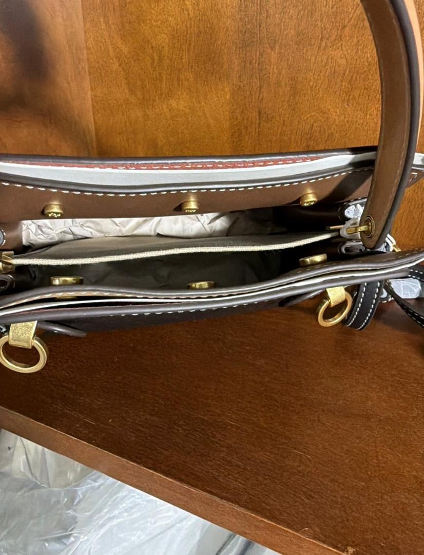 The Tory Burch Women's Petite Lee Radziwill Leather Double Bag in black is crafted from smooth leather and features a decorative gold-tone lock closure