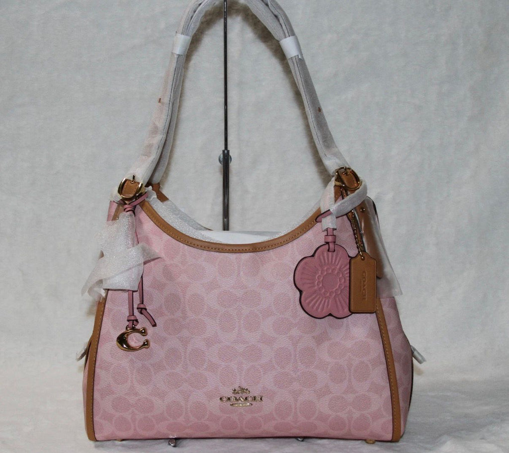 Coach Erin shoulder bag in powder pink signature canvas with smooth leather trim.