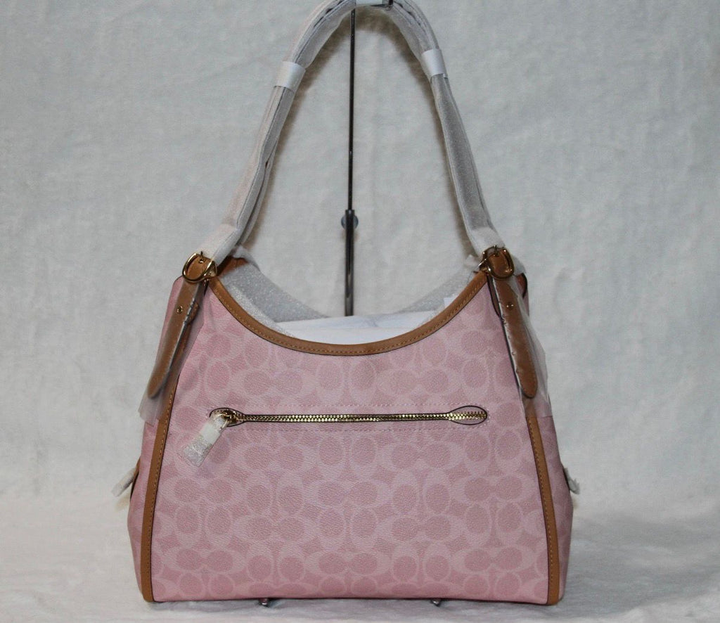 Coach Erin shoulder bag in powder pink signature canvas with smooth leather trim.