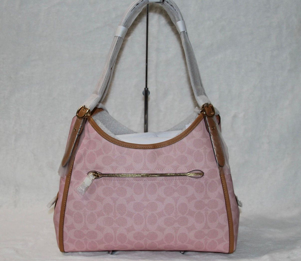 Coach Erin shoulder bag in powder pink signature canvas with smooth leather trim.