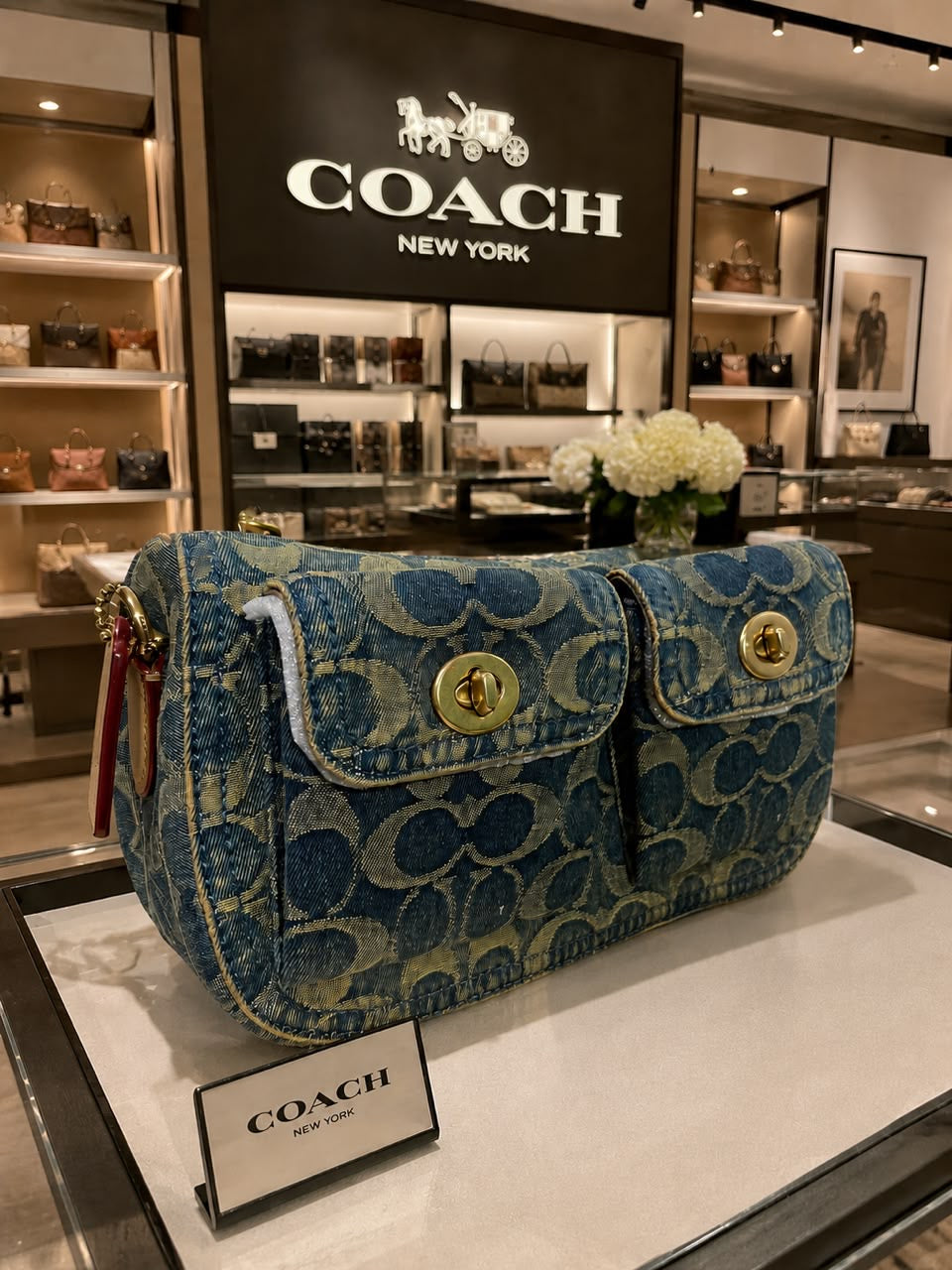 Coach Cargo Shoulder Bag in Signature Chambray denim with gold-toned turnlock pockets