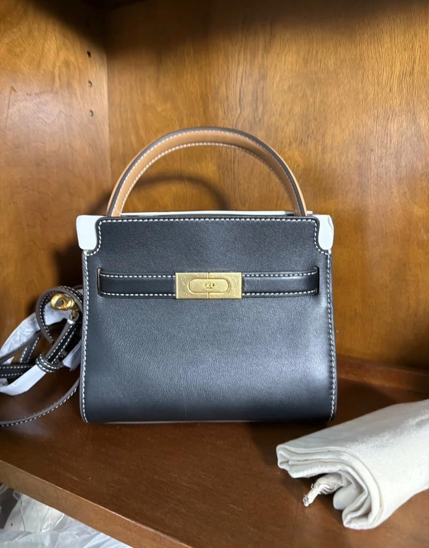 The Tory Burch Women's Petite Lee Radziwill Leather Double Bag in black is crafted from smooth leather and features a decorative gold-tone lock closure