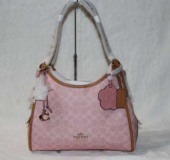 Coach Erin shoulder bag in powder pink signature canvas with smooth leather trim.
